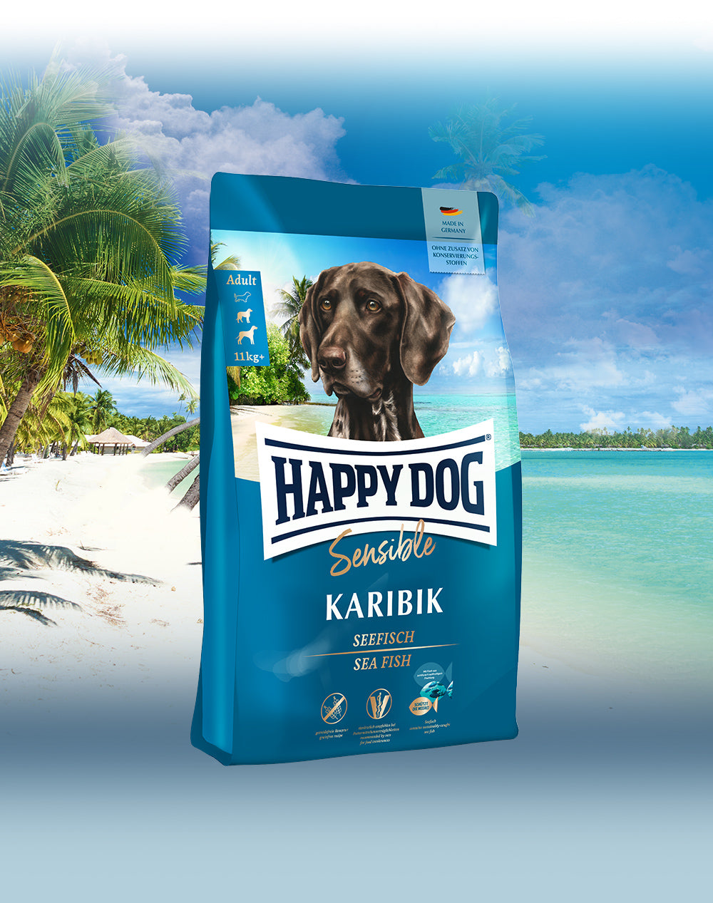 Das Hundefutter Happy Dog Sensible Karibik vor einem karibischen Sandstrand mit Palmen.